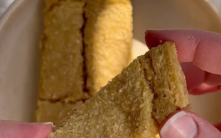 Hand holding golden-brown textured snack bar, ideal for mess-free mealtime
