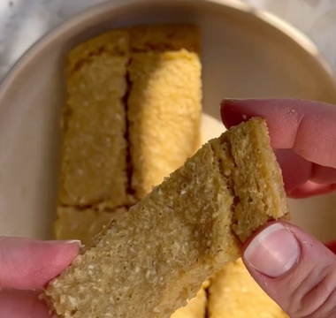 Hand holding golden-brown textured snack bar, ideal for mess-free mealtime