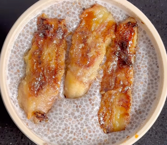 Caramelized banana slices in a speckled ceramic bowl, ready to serve