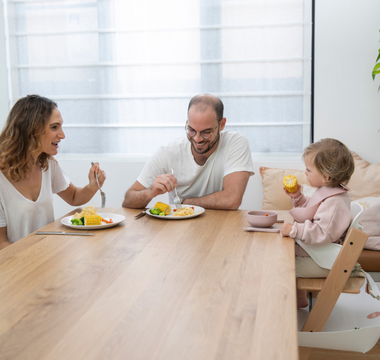 Family enjoying mess-free meal with food-catching mat, protecting floors and simplifying cleanup