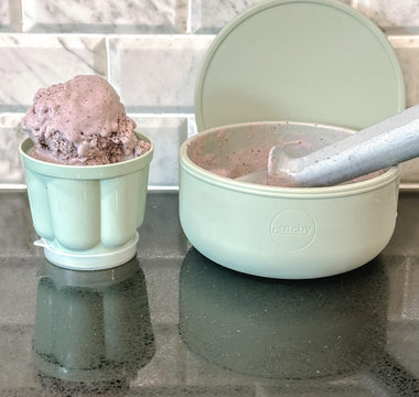Mint green Catchy bowls with chocolate ice cream, ideal for mess-free mealtime on kitchen counter.